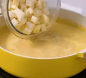 Simmering pot of Creamy Chicken Potato Chowder