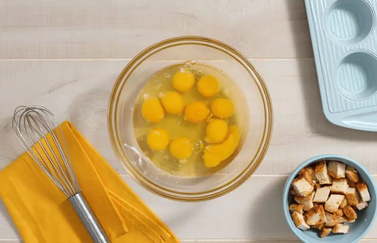 image of ten eggs cracked into a glass mixing bowl