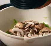 Mushrooms and other ingredients being added to a pot to make One Pot Chicken Cacciatore