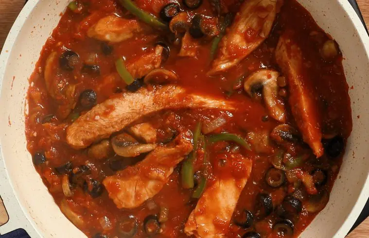 A close up of ingredients for One Pot Chicken Cacciatore simmering in a pot