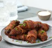 Image of finished Sweet and Spicy Bacon Wrapped BBQ Chicken Strips and ranch in a table setting